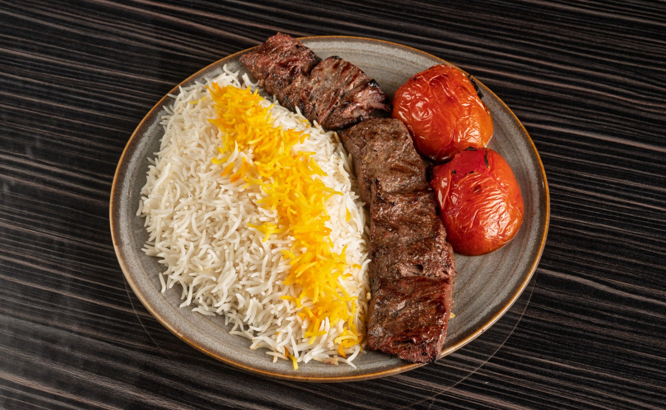 Chenjeh and Joojeh Kabab platter featuring grilled sirloin and saffron chicken at Aban Restaurant